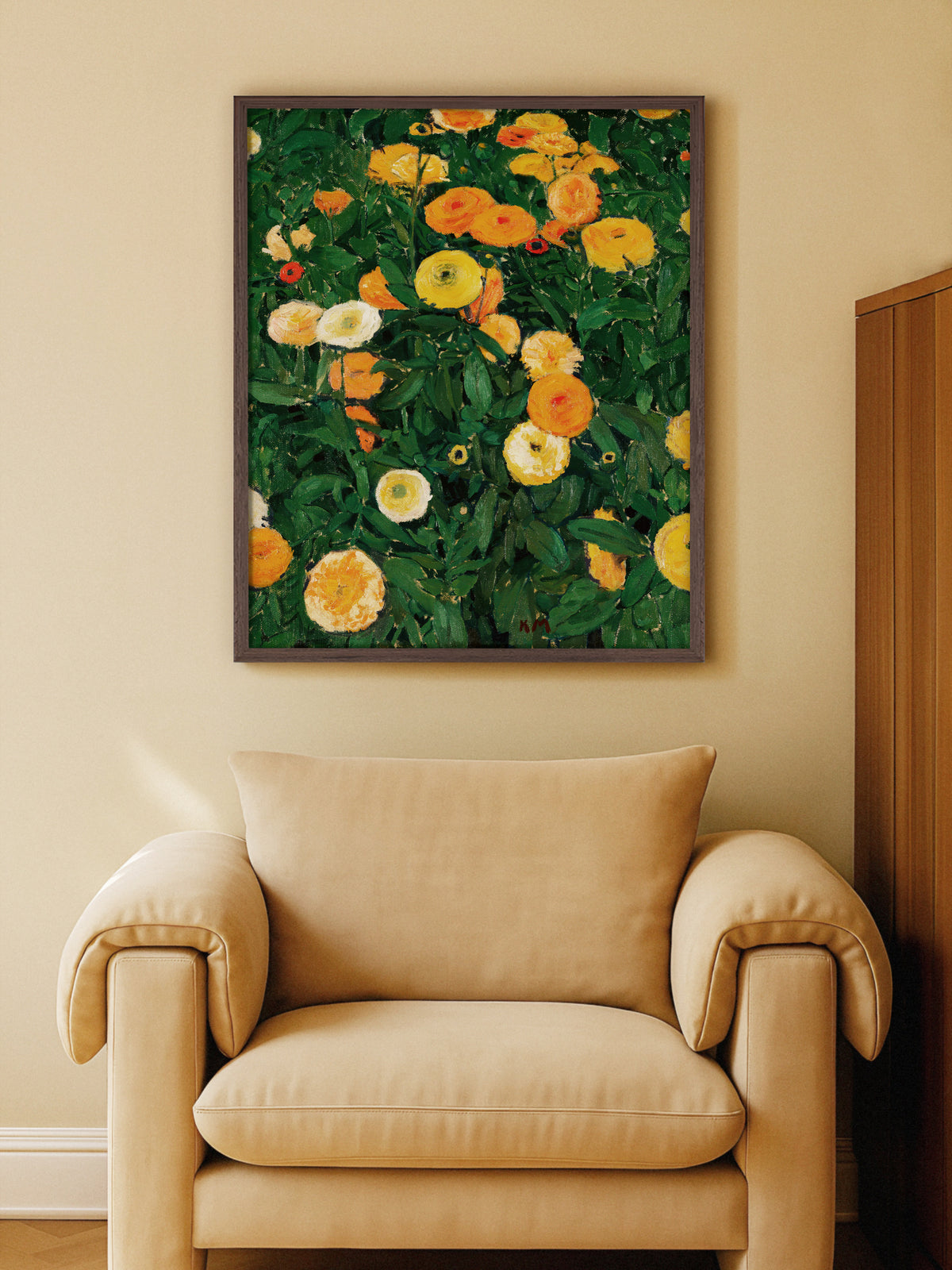 Blumen Wandbild mit Ringelblumen im dunklen Holzrahmen über einem beigen Sessel an einer warm gestrichenen Wand, rechts ein Holzschrank. Die orangen Blüten greifen die warmen Töne des Wohnzimmers auf.