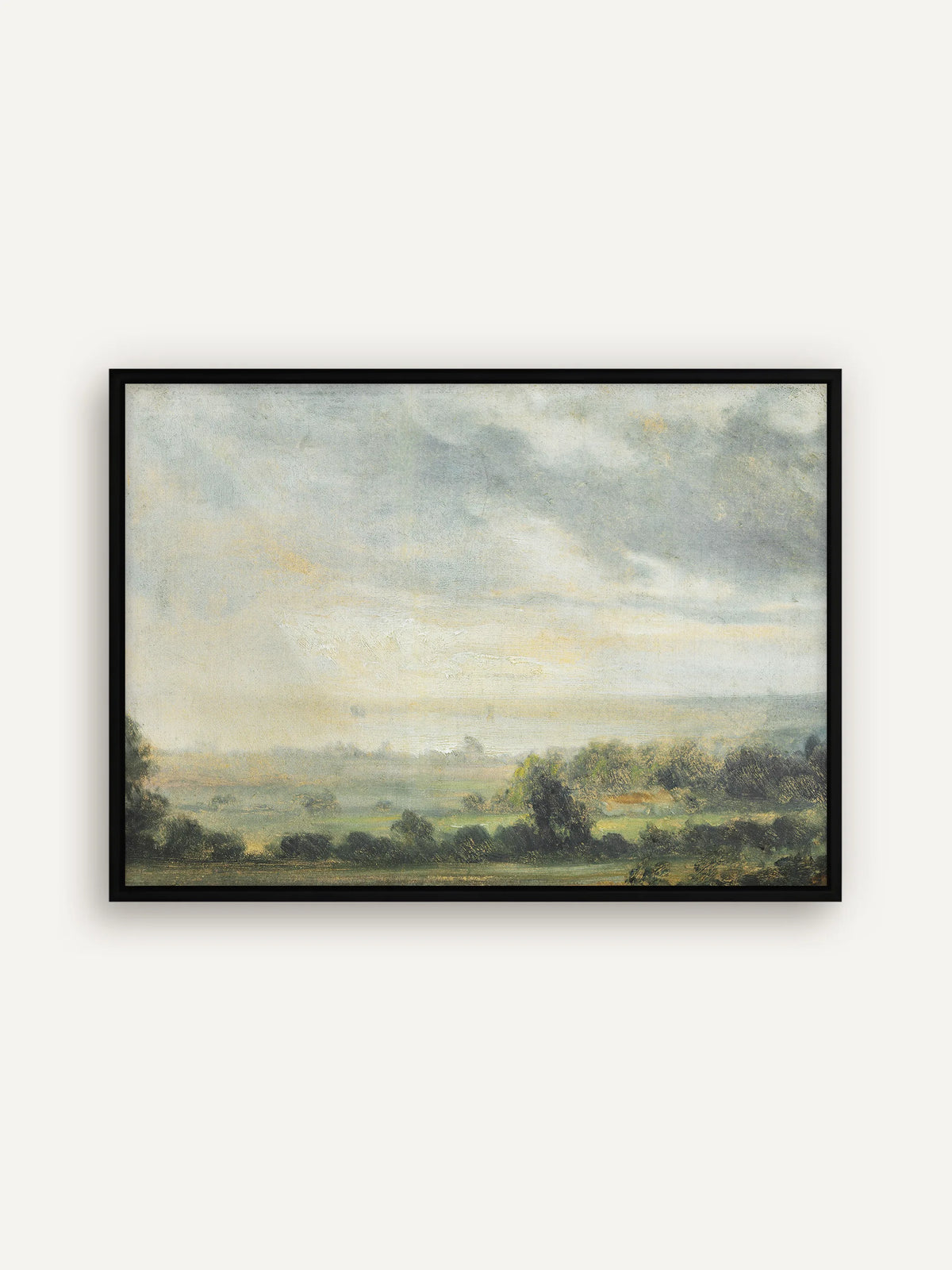 Leinwandbild mit weiter Landschaft im schwarzen Schattenfugenrahmen. Der dunkle Rahmen fasst den graublauen Himmel und die grünen Wiesen mit dunklen Baumgruppen klar ein. #Rahmen_Schwarz