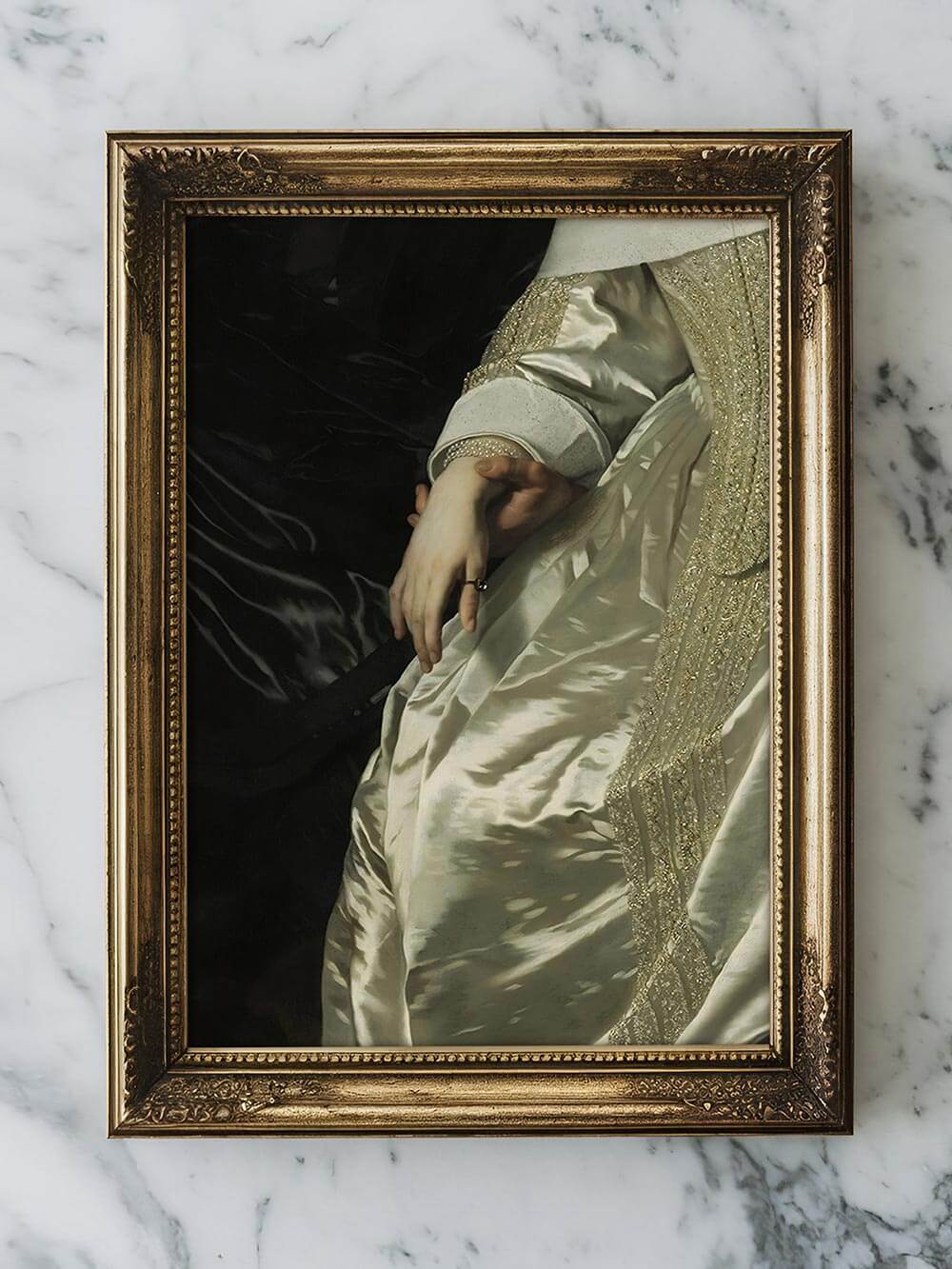 Gerahmter Kunstdruck liegt auf weißem Marmor. Der Ausschnitt zeigt Hand und elfenbeinfarbenes Kleid mit goldenen Stickereien, die glänzende Textur wirkt edel und zeitlos.