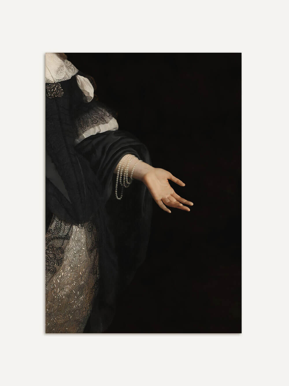 Klassisches Porträt-Detail einer ausgestreckten Hand in schwarzer Kleidung und Perlenschmuck, ungerahmt an einer weißen Wand.