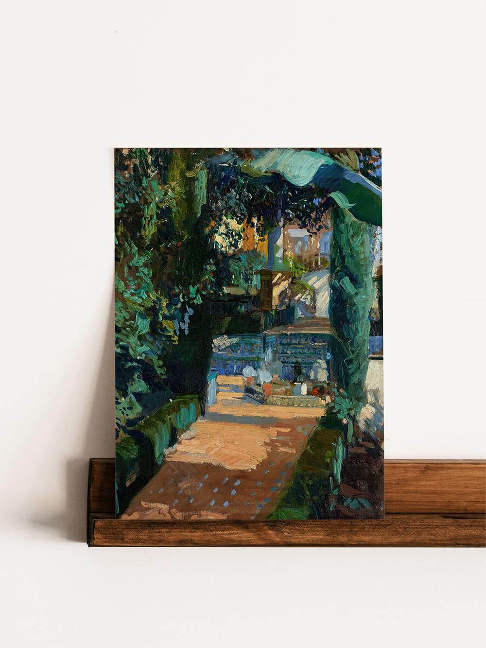 Impressionistisches Landschaftsposter mit einem mediterranen Innenhofmotiv, auf einem Holzregal ausgestellt. Die üppige grüne Natur, warme Lichtakzente und ausdrucksstarke Textur verleihen dem Werk Tiefe. Eleganter Akzent für Wohn- und Arbeitsbereiche.