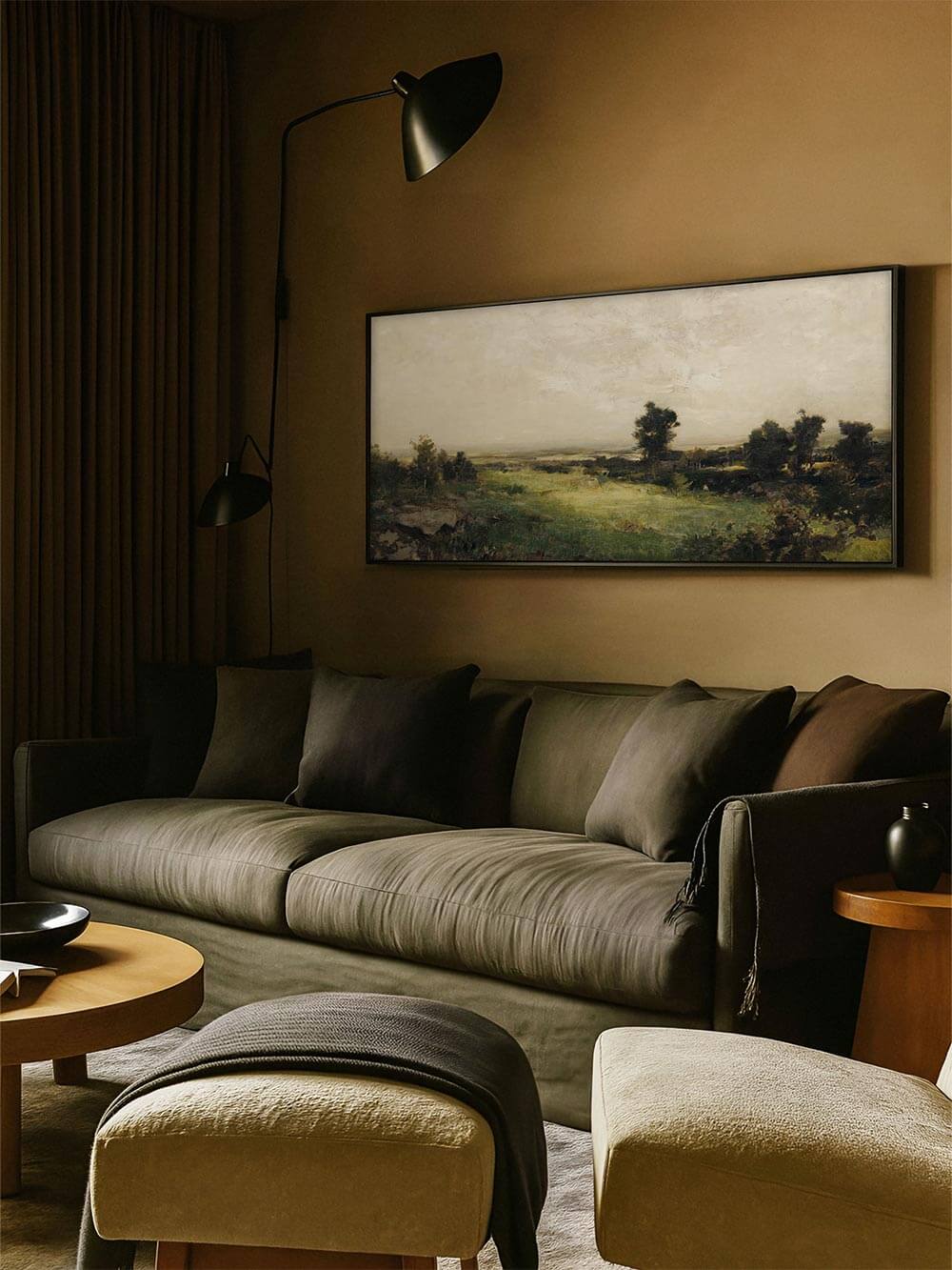 Panorama-Landschaft mit sanften Grüntönen über einem olivfarbenen Sofa in einem moody Wohnzimmer. Das stimmungsvolle Wandbild bringt Ruhe und Tiefe in moderne, dunkle Interieurs – ideal als Kunstdruck oder Poster.