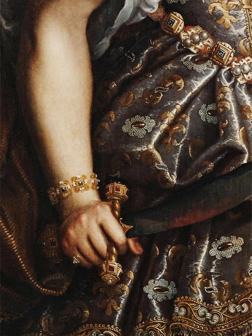 Nahaufnahme eines barocken Gemäldes mit kunstvoll besticktem, goldverziertem Kleid, opulenten Schmuckdetails und einer Hand, die einen Dolch hält. Die dunkle, dramatische Farbpalette unterstreicht den historischen Charakter.