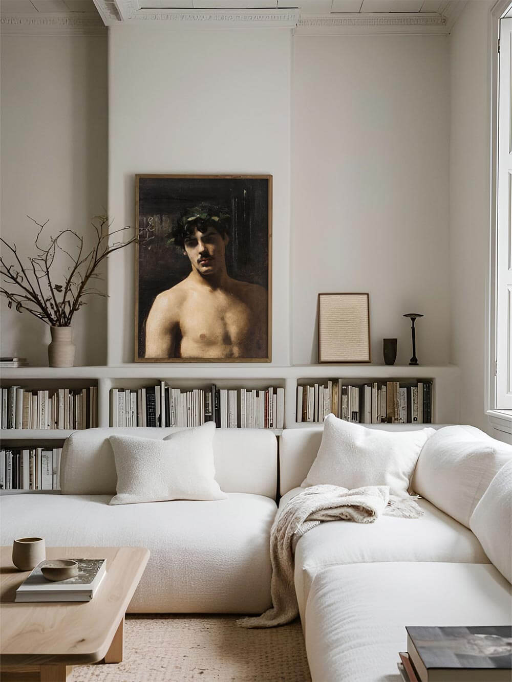 Eleganter Kunstdruck eines männlichen Porträts mit Lorbeerkranz, stilvoll gerahmt und über einer Bücherwand im modernen Wohnzimmer platziert. Die dunklen Farbtöne des Kunstwerks setzen einen dramatischen Akzent im hellen, minimalistischen Interior.